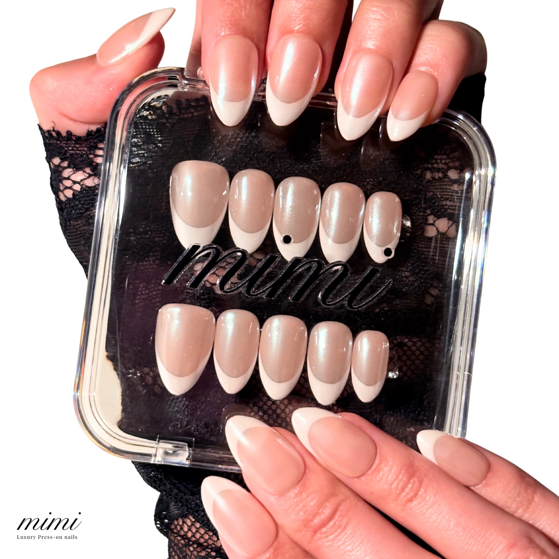 Coffret transparent Mimi contenant les press-on Silky French faits main, gel et acrylique, accompagné d’une main portant la french amande finition nacrée.